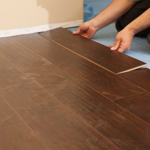 Man Installing New Laminate Wood Flooring